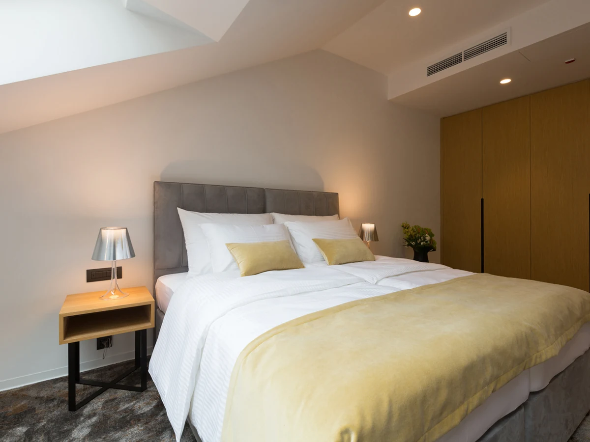 Loft bedroom with sloped ceilings painted professionally in Ipswich