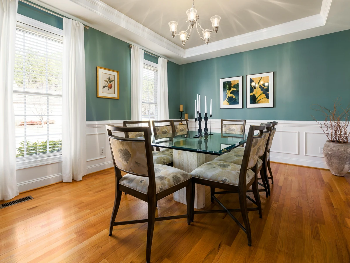 Dining room with teal walls and wainscoting in Ipswich