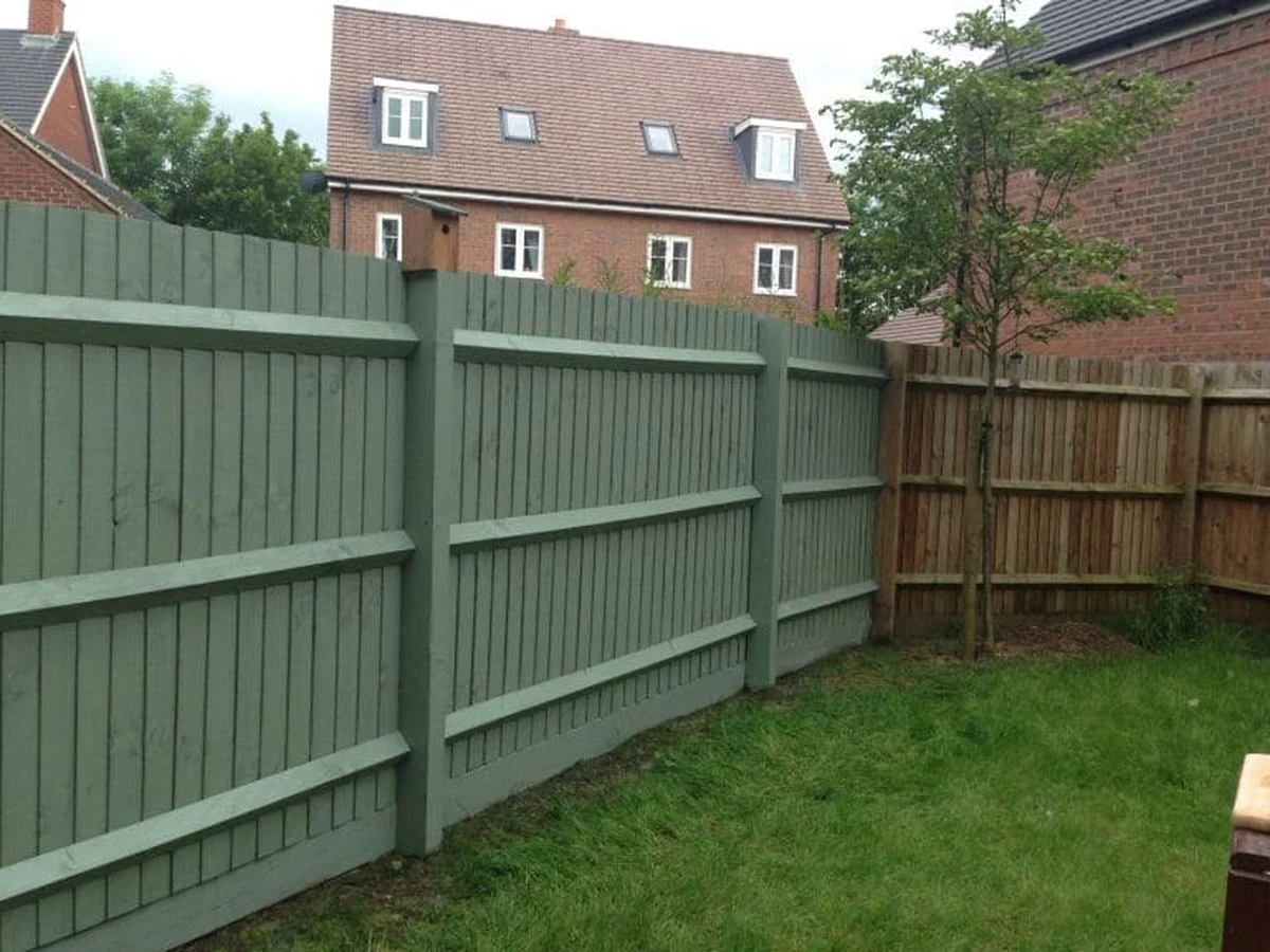 Green stained wooden fence panel in Ipswich garden