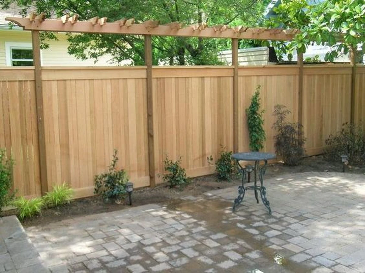 Tall wooden garden fence painted in Ipswich by Ipswich Painters, professional fence staining