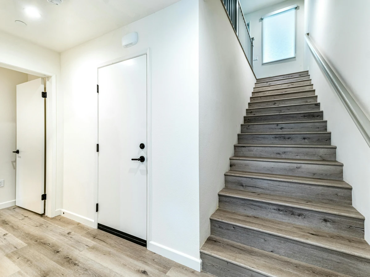 Modern staircase with white walls and painting in Ipswich